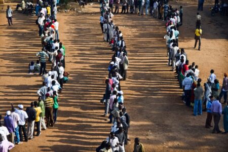 Sven Torfinn. People wait in line to cast their votes. 2011.
