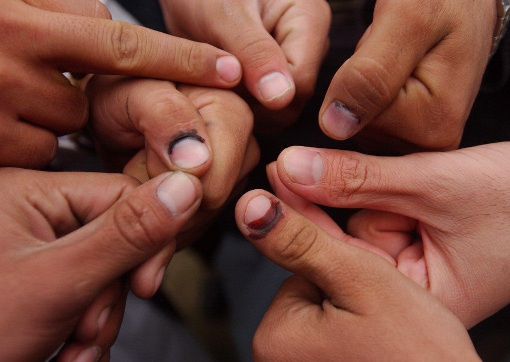 Jeroen Oerlemans. Voters show their thumbs, which earlier that day had been dipped in a supposedly indelible ink to indicate that they had voted. 2004.