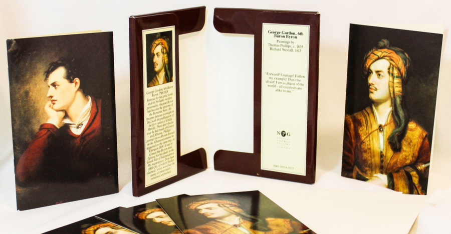 A set of stationery items featuring portraits of George Gordon, 6th Baron Byron (Lord Byron). The items include notecards and a presentation folder, adorned with classical painted portraits of Byron. One image shows him in a red coat, resting his head on his hand, while another shows him dressed in ornate Eastern-style attire with a turban. The folder includes biographical information about Byron and references to paintings by Thomas Phillips (c. 1835) and Richard Westall (1813), with the National Portrait Gallery logo and ISBN visible.