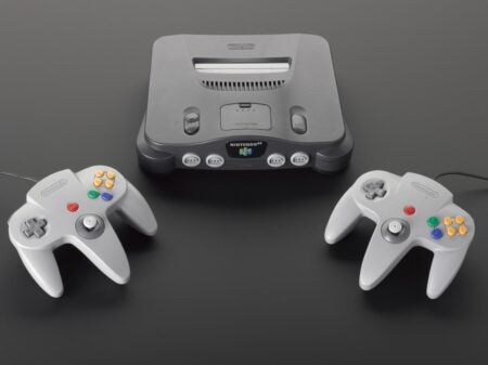A gray Nintendo 64 console framed by a controller on either side. 