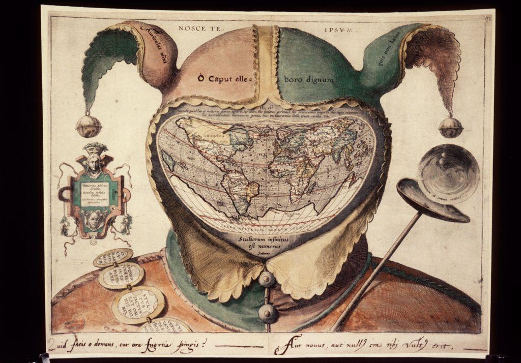 An antique map of the world shaped like a jester’s head, with the continents depicted inside the fool’s cap and Latin inscriptions across the design.