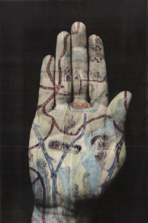 A photographic image of an open hand overlaid with a map featuring roads, rivers, and buildings, blending human anatomy with cartographic lines.