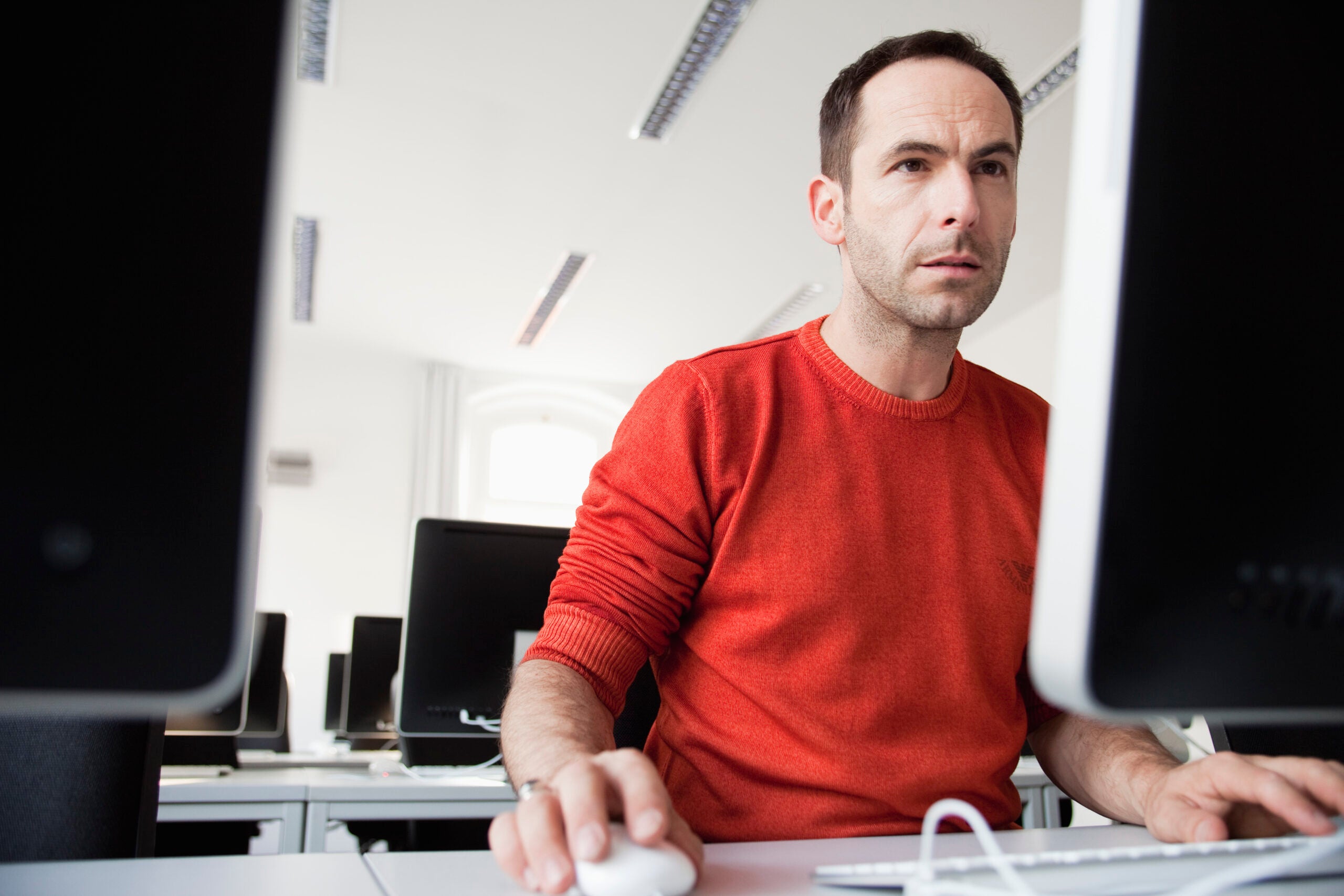 Man sitting at terminal in lecture hall