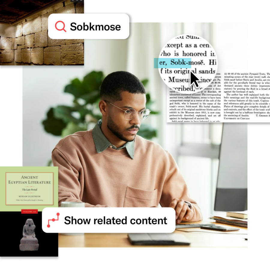 Overhead view of two students sitting at a round table with laptops, books, and coffee cups, collaborating on research in a bright, open space.