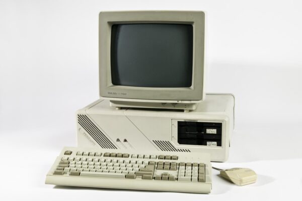 Desktop microcomputer from the mid-1980s with a beige rectangular metal case, labeled Ferranti PC 2860-AT. The unit is wide and low-profile, with ventilation slats and front-facing drive bays, representing early personal computing hardware.